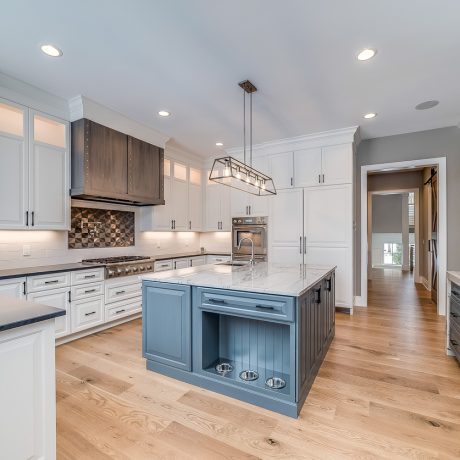Natural engineered wood flooring with a perfect place to feed the dog inside the kitchen island